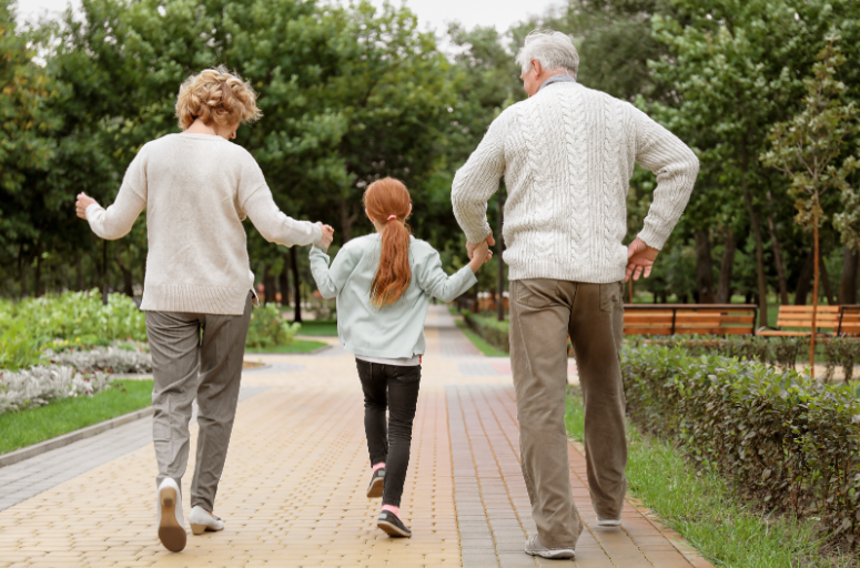 Grandparents walking with grandchild